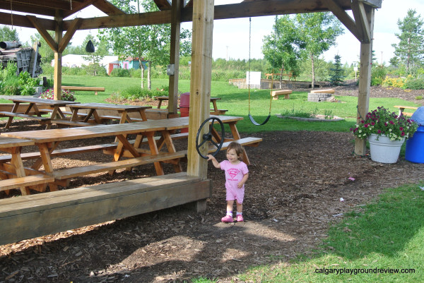 Covered picnic area with steering wheel. 