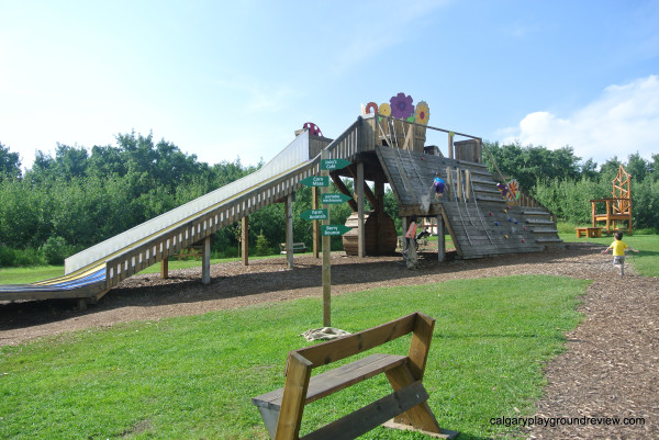 Large wooden play structure with slides