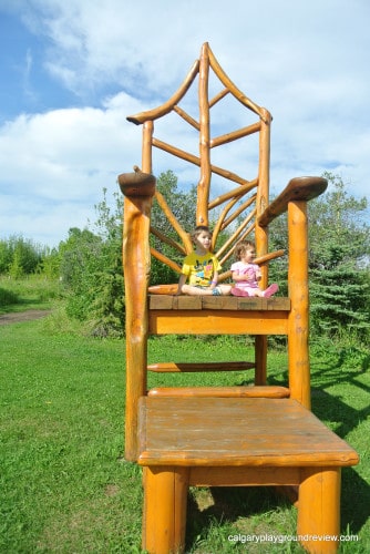 Giant wooden chair with two kids 