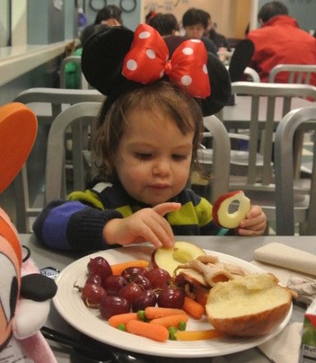 Kid eating kids meal at Flo's Cafe in Disneyland