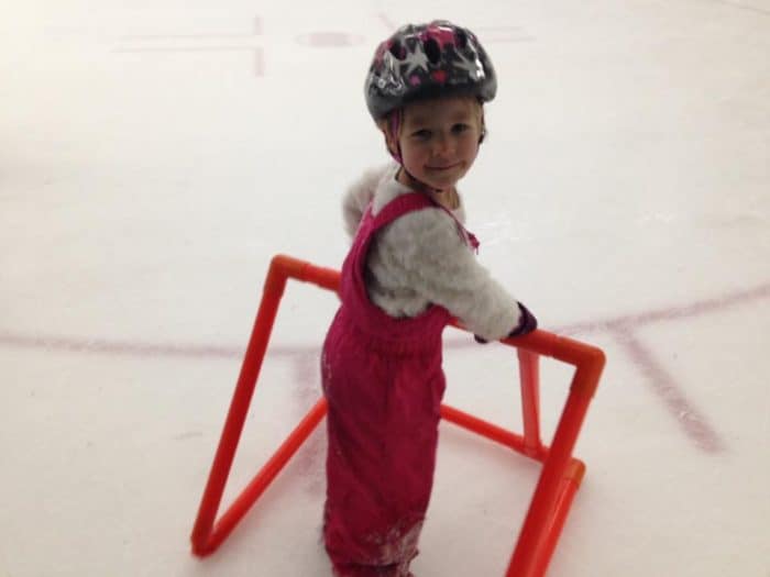 child indoor skating with skate support - budget friendly winter Fun in Calgary