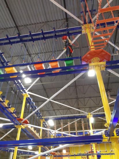 Child climbing around the Indoor Aerial Rope Course - at the Big Box