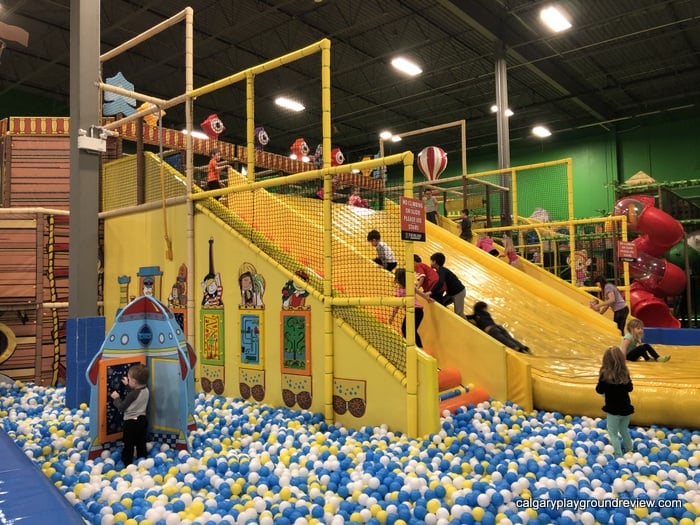 Kids climbing up the wide slide at the Big Box